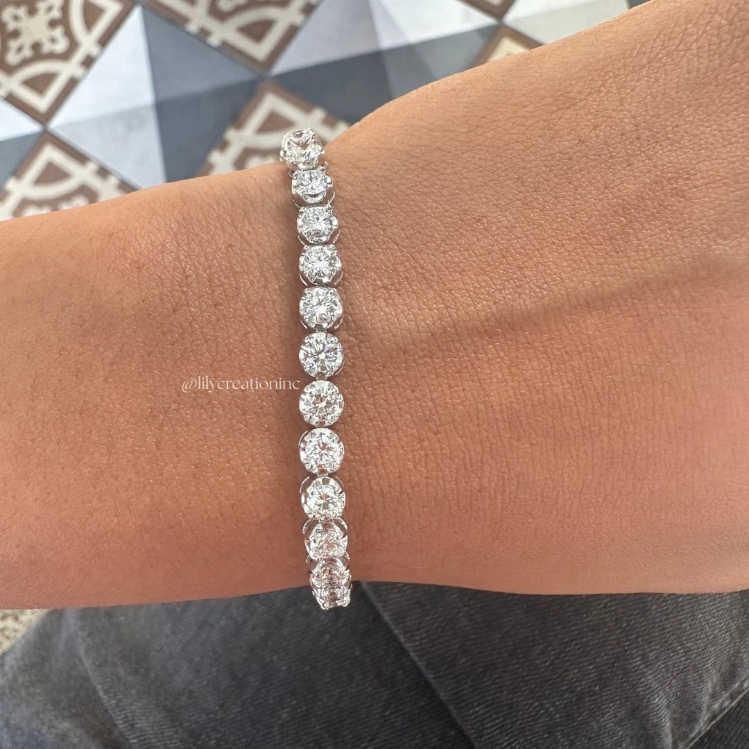 6 Carat Crown Setting Round Diamond Tennis Bracelet in 14k White Gold: 14k White Gold Crown Setting Round Diamond Tennis Bracelet/Length of the Bracelet: 7 Inches/Total Diamond Weight: 6 Carat in a 7 inch Bracelet/Solid 14K White Gold and Conflict free Lab grown Diamonds