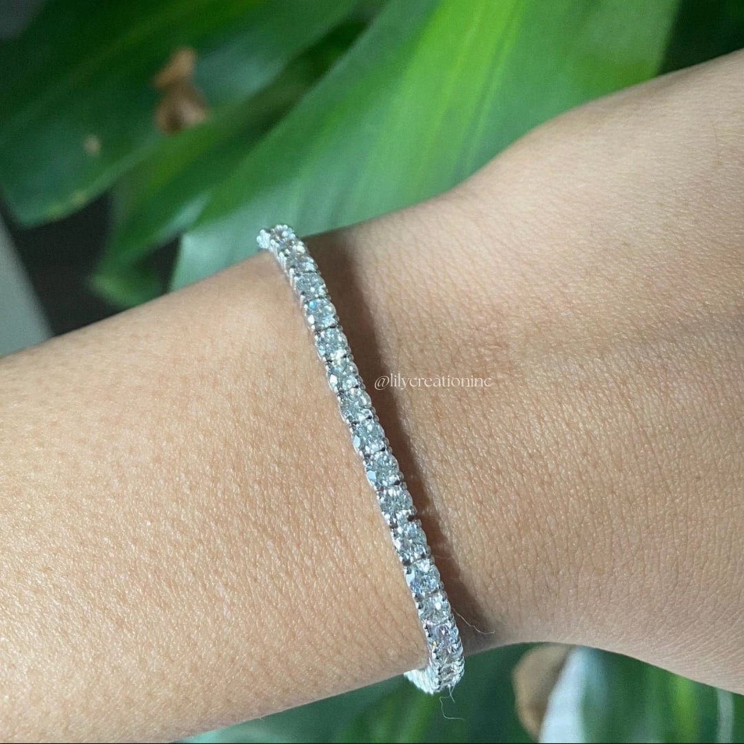 6 Carat Round Diamond Tennis Bracelets in 14k White Gold: 14k White Gold Round Diamond Tennis Bracelet/Length of the Bracelet: 7 Inches/Total Diamond Weight: 6 Carat in a 7 inch Bracelet/Solid 14K White Gold and Conflict free Lab grown Diamonds/Diamond Quali