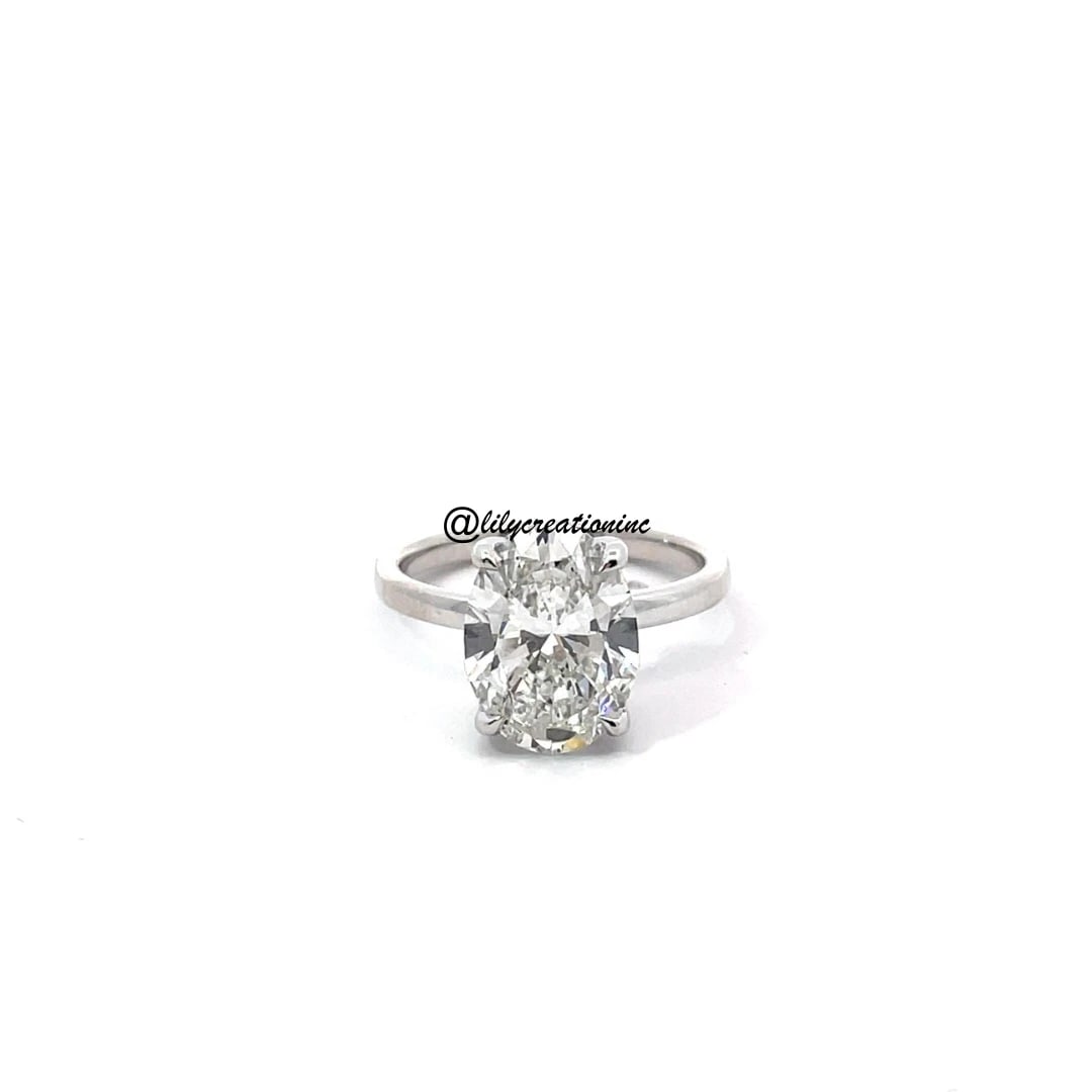 5 Carat Oval hidden halo Diamond Engagement Ring in 14k White Gold: 14k White Gold Oval Hidden Halo Diamond Engagement Ring /Total Diamond Weight: 5 Carat / Center Stone : 4 Carat / Side Stone : 0.15 Carat Solid 14k White Gold & Conflict - Free Lab Grown Diamond/Diamo