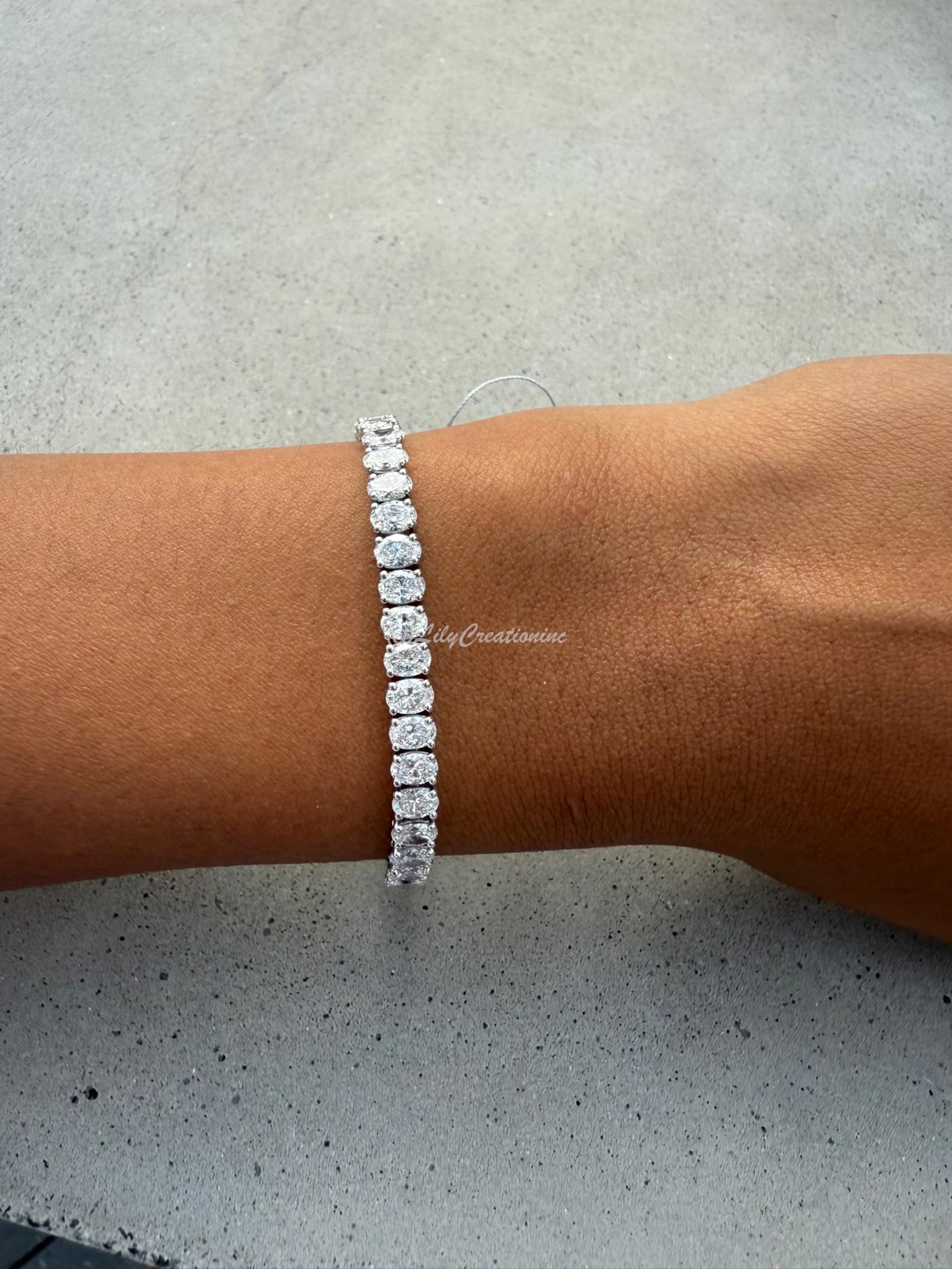 10 Carat Oval North to South Diamond Tennis Bracelet in 14k White Gold: 14k White Gold Oval North to South Diamond Tennis Bracelet/Length of the Bracelet: 7 Inches/Total Diamond Weight: 10 Carat in a 7 inch Bracelet/Solid 14K White Gold and Conflict free Lab grown Diamond