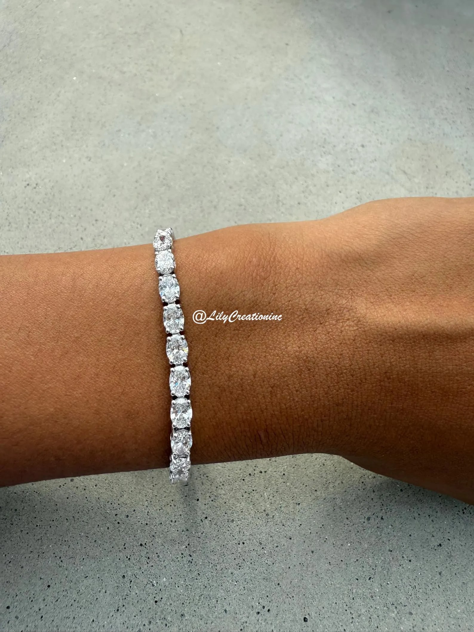 12 Carat Oval East to West Diamond Tennis Bracelet in 14k White Gold: 14k White Gold Oval East to West Diamond Tennis Bracelet/Length of the Bracelet: 7 Inches/Total Diamond Weight: 12 Carat in a 7 inch Bracelet/Solid 14K White Gold and Conflict free Lab grown Diamonds/