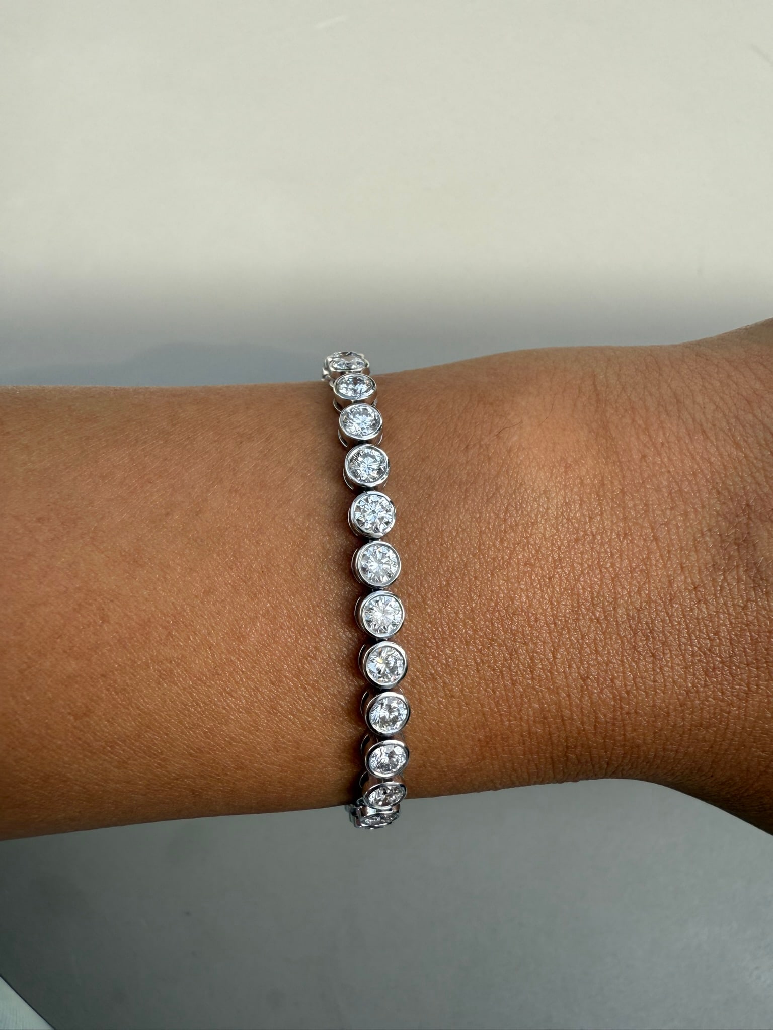 6 Carat Round Bezel Set Diamond tennis bracelet in 14k White Gold: 6 Carat Bezel Diamond tennis Bracelet/Length of the Bracelet: 7 Inches/Total Diamond Weight: 6 Carat in a 7 inch bracelet/Solid 14K White Gold and Conflict free Lab grown Diamonds/Diamond Quality: E I