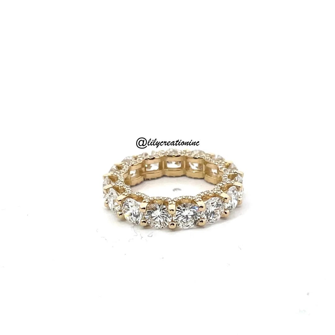 5 Carat Round U Prong Diamond Eternity Band With Side Diamonds in 14k Yellow Gold: 14k Yellow Gold Round U Prong Diamond Eternity Band /Total Diamond Weight: 5 Carat / Side Stone : 0.50 Carat Solid 14k Yellow Gold & Conflict - Free Lab Grown Diamond/Diamond Quality : E in Color & VV