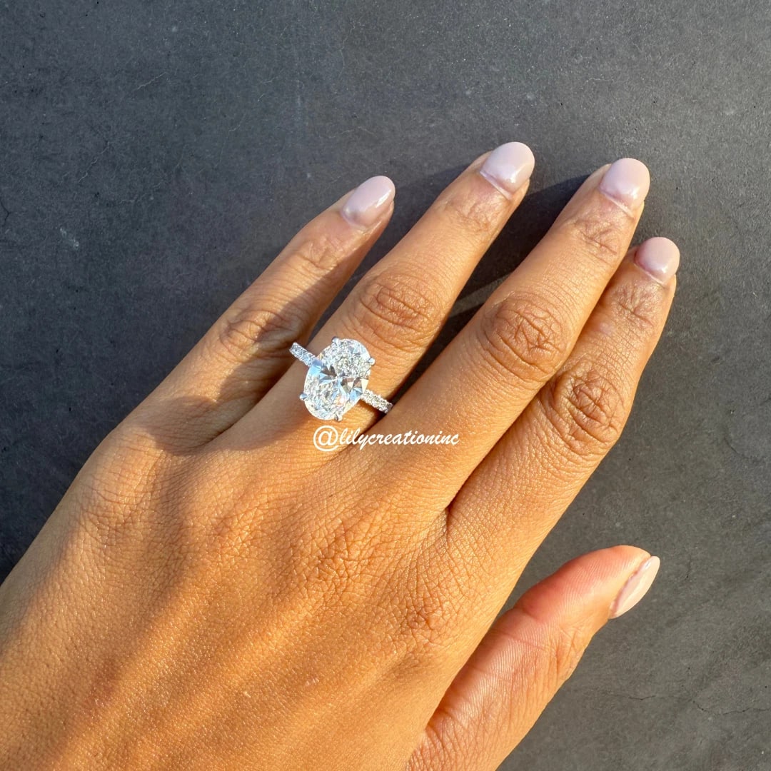 10 Carat Oval Diamond Engagement Ring w/ Halfway Pavé Band in 14k White Gold: 14k White Gold Oval w/ Halfway Pave Diamond Engagement Ring /Total Diamond Weight: 10 Carat / Center Stone : 10 Carat / Side Stone : 1/3 Carat Solid 14k White Gold & Conflict - Free Lab Grown Diamond/