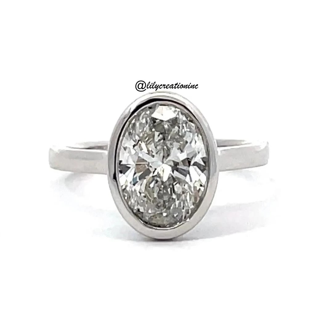 3 Carat Oval Bezel Set Diamond Engagement Ring in 14k White Gold: 14k White Gold Oval Bezel Set Diamond Engagement Ring /Total Diamond Weight: 3 Carat Solid 14k White Gold & Conflict - Free Lab Grown Diamond/Diamond Quality : E in Color & VVS-VS in Clarity/Certifica