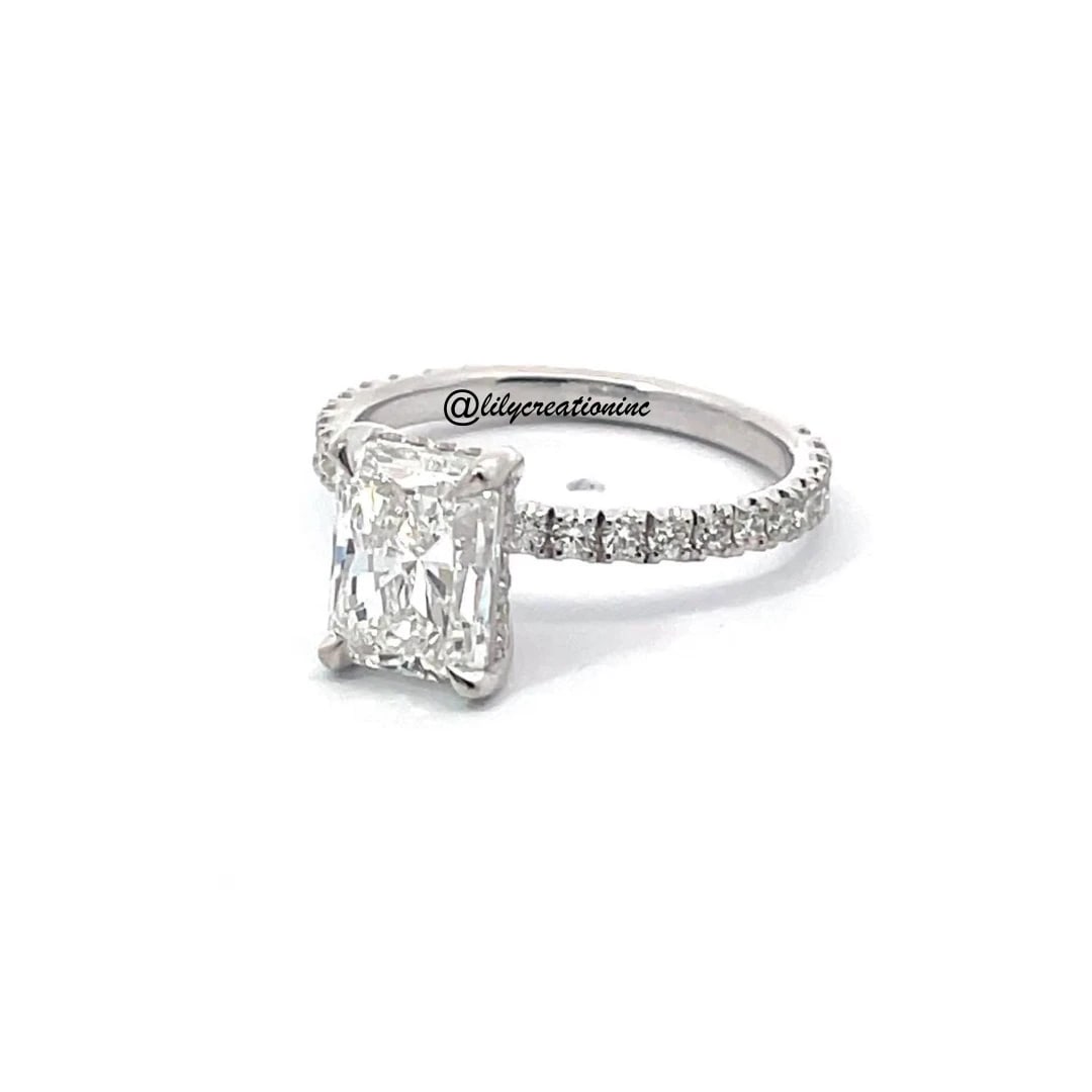 3 Carat Radiant Cut Hidden Halo Diamond Engagement Ring in 14k White Gold: 14k White Gold Radiant Cut Hidden Halo Diamond Engagement Ring /Total Diamond Weight: 3 Carat / Center Stone : 2 Carat / Side Stones : 0.45 Carat Solid 14k White Gold & Conflict - Free Lab Grown Diamo