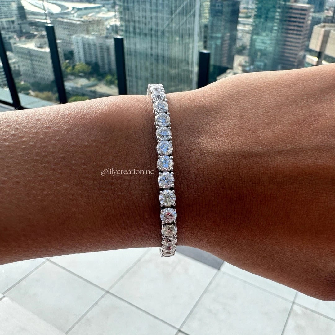 12 Carat Round Diamond Tennis Bracelet in 14k White Gold: 14k White Gold Round Diamond Tennis Bracelet/Length of the Bracelet: 7 Inches/Total Diamond Weight: 12 Carat in a 7 inch Bracelet/Solid 14K White Gold and Conflict free Lab grown Diamonds/Diamond Qual