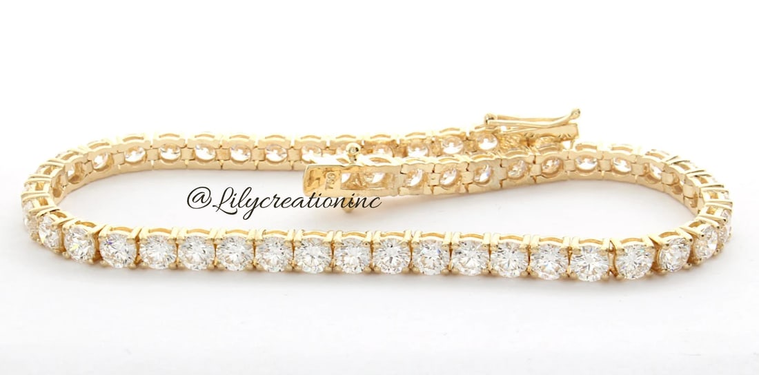 12 Carat Round Diamond Tennis Bracelet in 14k Yellow Gold: 14k Yellow Gold Round Diamond Tennis Bracelet/Length of the Bracelet: 7 Inches/Total Diamond Weight: 12 Carat in a 7 inch Bracelet/Solid 14K Yellow Gold and Conflict free Lab grown Diamonds/Diamond Qu
