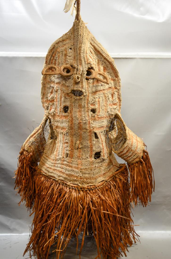 Papua New Guinea Det crocheted body mask, Smithsonian: Papua New Guinea crocheted body mask, 53" x 24" w x 13" d, purchased in Irian Jaya, in 1992, Description: Head and body of mask are knotted from the inner back of the paper mulberry tree, After the ba