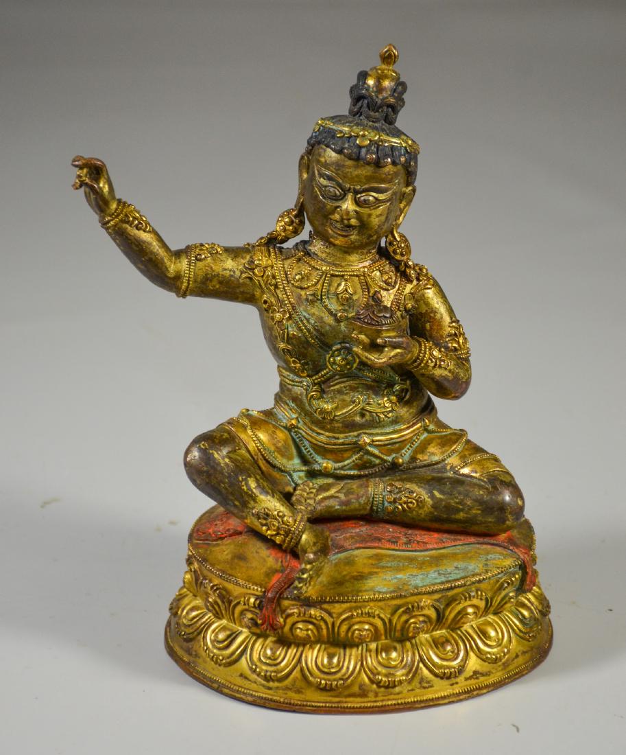Tibetan gilt bronze figure holding a kapala cup, with (1 of 6)