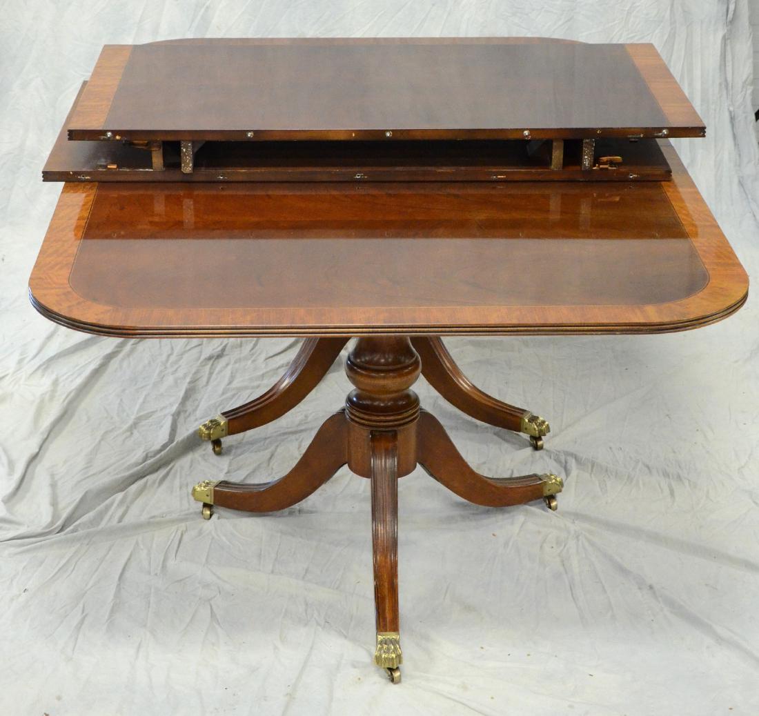 Henredon Pedestal Dining Room Table: Henredon banded mahogany double pedestal dining room table, 2 24" skirted leaves, 68" l x 46" w, 9'8" extended