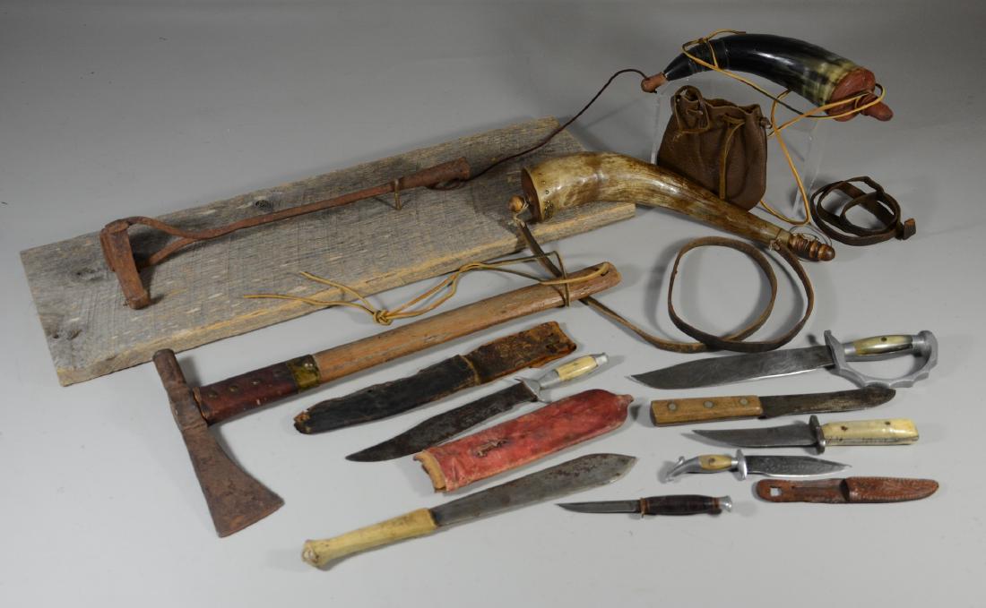 7 Hunting knives, 2 Powderhorns, axe, branding iron: Primitive lot: (7) Hunting knives, (2) Powderhorns, Hand forged axe, Antique branding iron mounted on old barn wood, iron 16-1/2", overall 20-3/4". Details: (7) Hunting knives, to include one tribal k