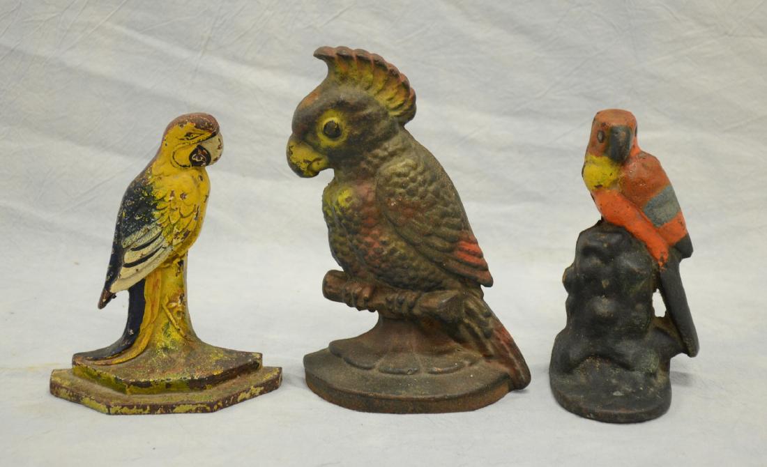 (3) Cast iron painted parrot doorstops: (3) Cast iron painted parrot doorstops, tallest 8" h