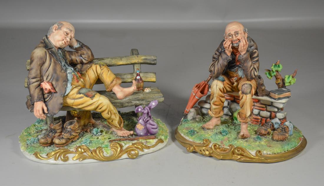 Pair of Capodimonte style figure of seated hoboes: Pair of Capodimonte style figure of seated hoboes, marked "Italy", largest 10" long