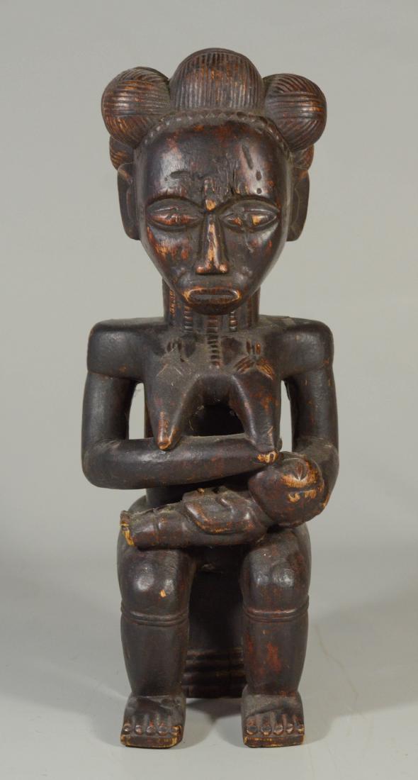 African carved wood figure of nursing mother seated on (1 of 2)