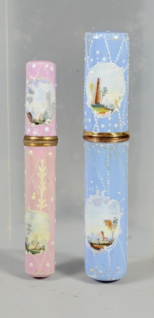 (2) Battersea Bilston English enamel needle cases: (2) Battersea Bilston English enamel needle cases bodkins, both painted with pastoral scenes, longest 5", minor wear to base of pink case