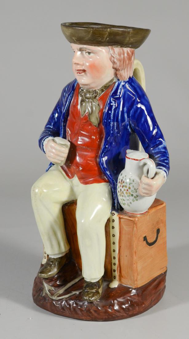 Large unmarked toby jug, sailor seated on trunk (1 of 5)