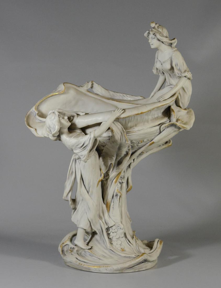 Royal Dux porcelain art nouveau compote: Royal Dux porcelain art nouveau compote, 2 maidens surrounding a shell form bowl on a tree trunk base, base impressed 875, XV, with pink triangular factory seal, matte finished ivory glaze with gold h