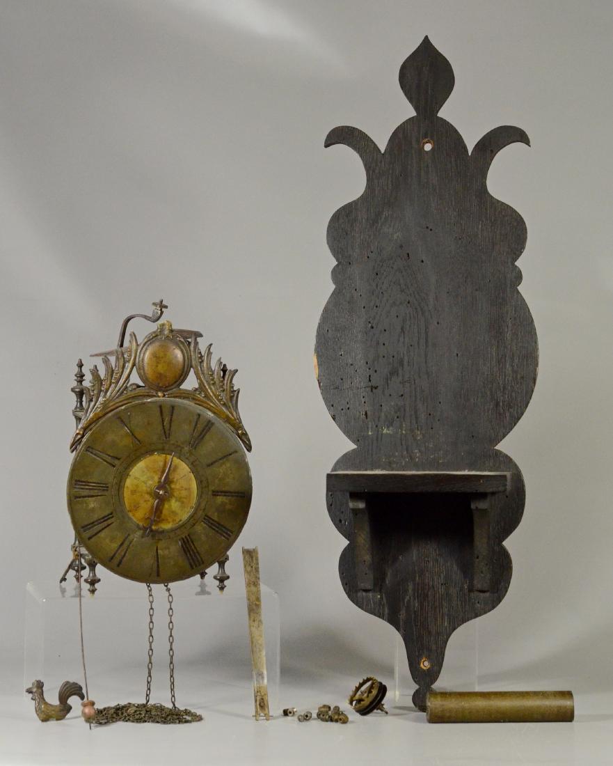 17th/18th C iron and brass lantern clock: 17th/18th c iron and brass lantern clock, lacking strike bell, rooster crest broken off but present, with chain and weight, a crown escapement wheel unattached, about 13" high, perhaps French