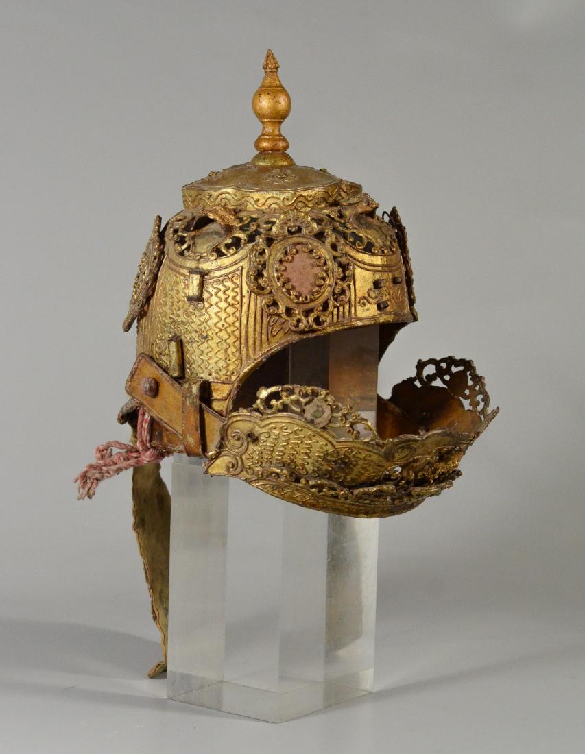 Thai/Indonesian theatrical headdress, gilt finish, 10": Thai/Indonesian theatrical headdress, gilt finish, 10" h, missing two jewels on the moving part of the headdress, some loss to finish, kink in the back