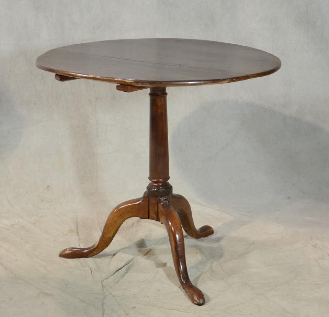 Cherry Queen Ann tilt top tea table, 18th c: Cherry Queen Ann tilt top tea table, flat edge top, pedestal base, round tapered stem on tripod base, cabriole legs with pad feet, 18th c, 26"h x 29-1/4"diameter, repairs and old splits