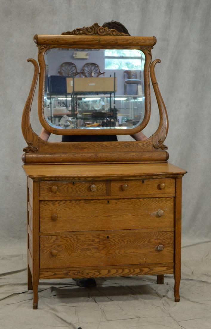 Oak dresser w/beveled mirror: Oak dresser w/ beveled mirror, scrolled crest over rolling pin top, chest 2 drawers over 2 drawers, mushroom pulls, paneled sides, chest 34"h x 40"w x 20-1/2"d 