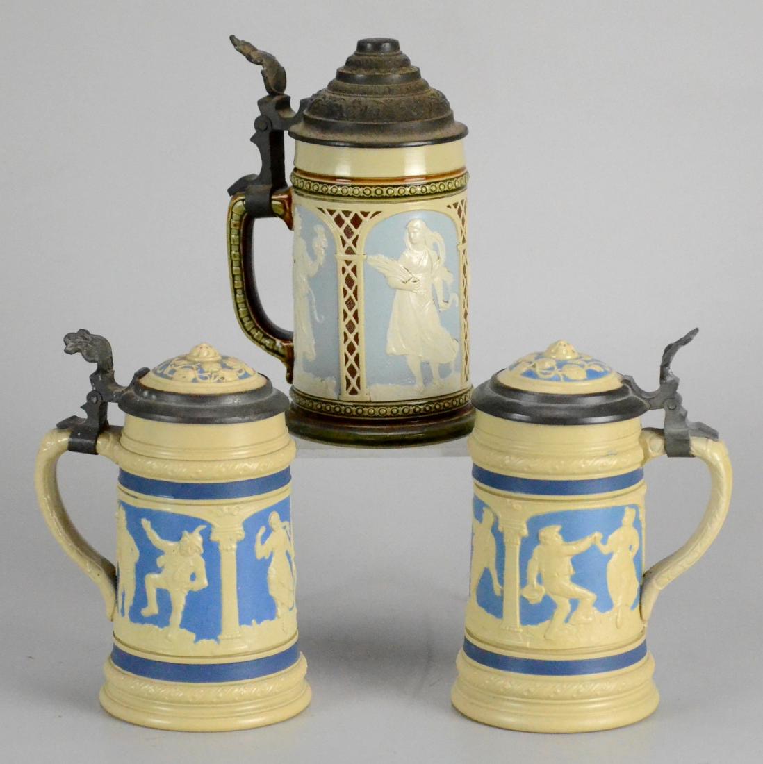 (3) Mettlach relief steins, 0.3 L (1 of 3)