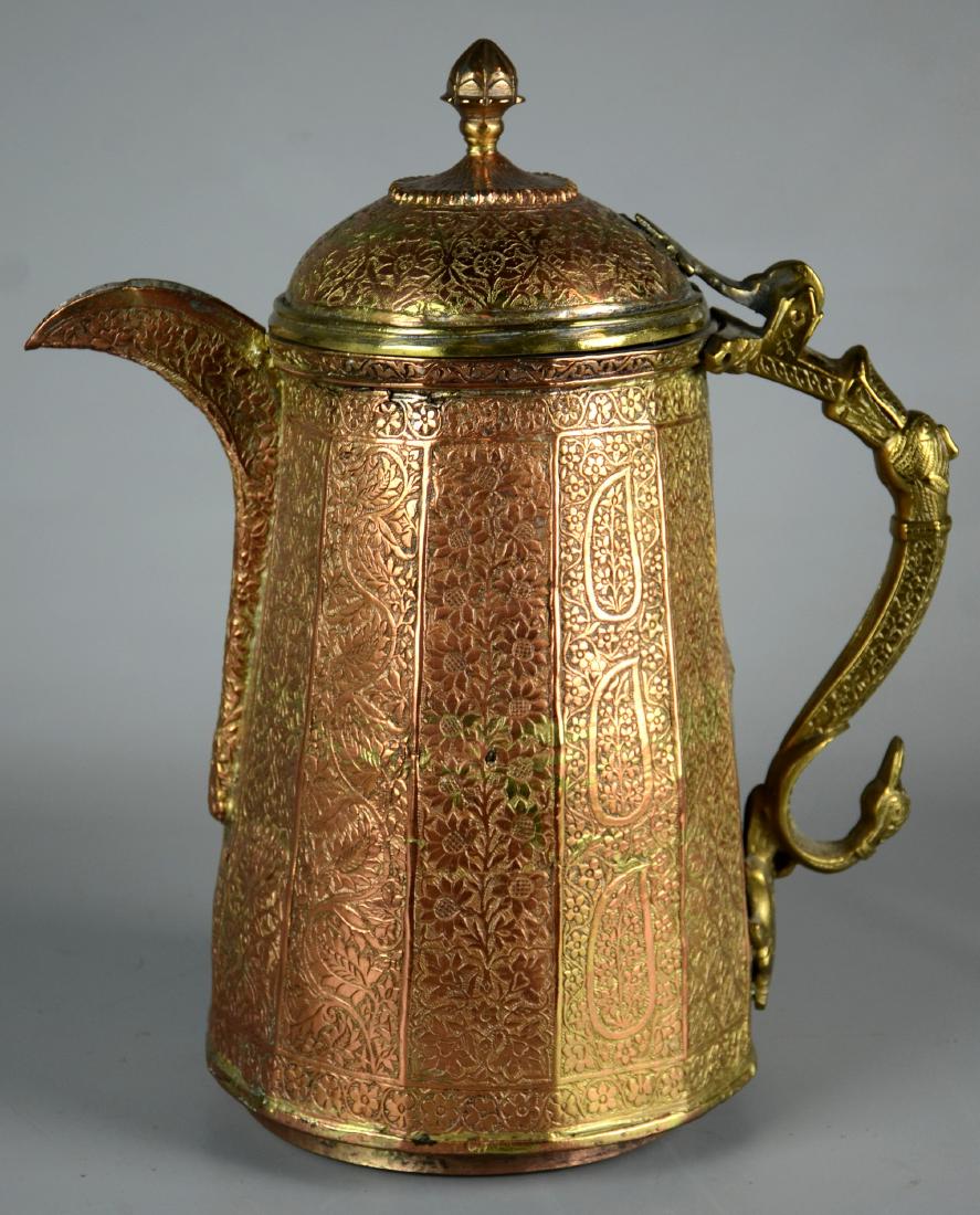 Indian Brass and Copper Pitcher: Indian hammered brass and copper pitcher with mythical animal handle, 13-1/2" h