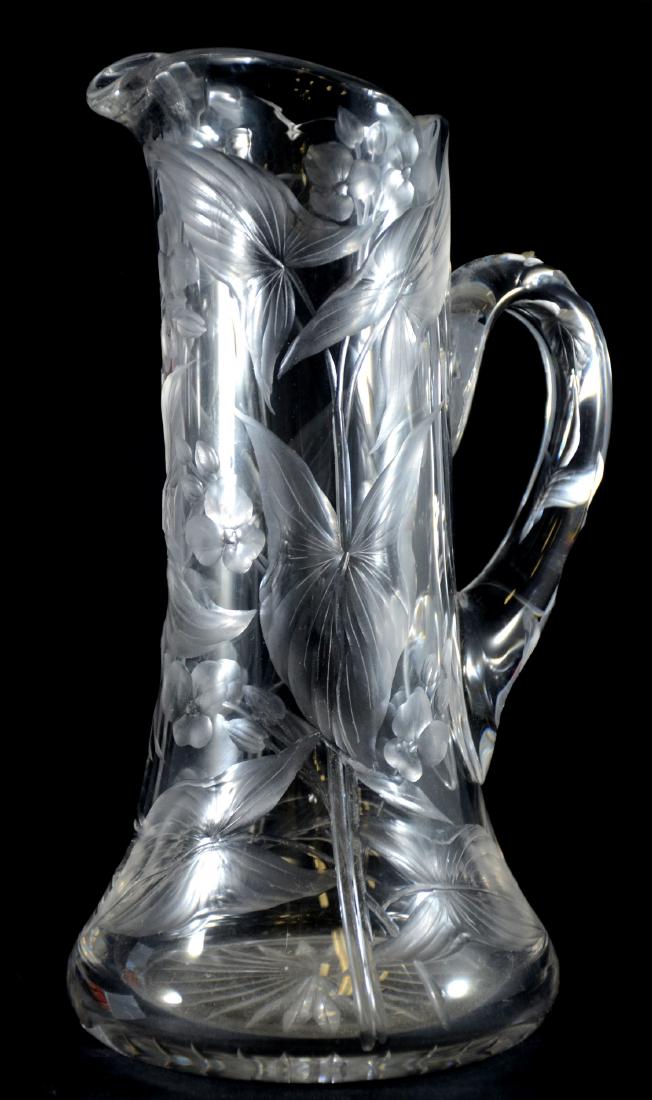 Intaglio cut orchid pattern pitcher: Intaglio cut orchid pattern pitcher, unsigned, 11" tall, no damage noted