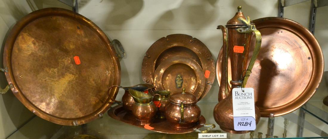 Shelf #34 - Hammered Copper Serveware: Shelf #34 - Hammered copper serveware including trays, plates, ewer, pitchers, and lidded sugar bowl