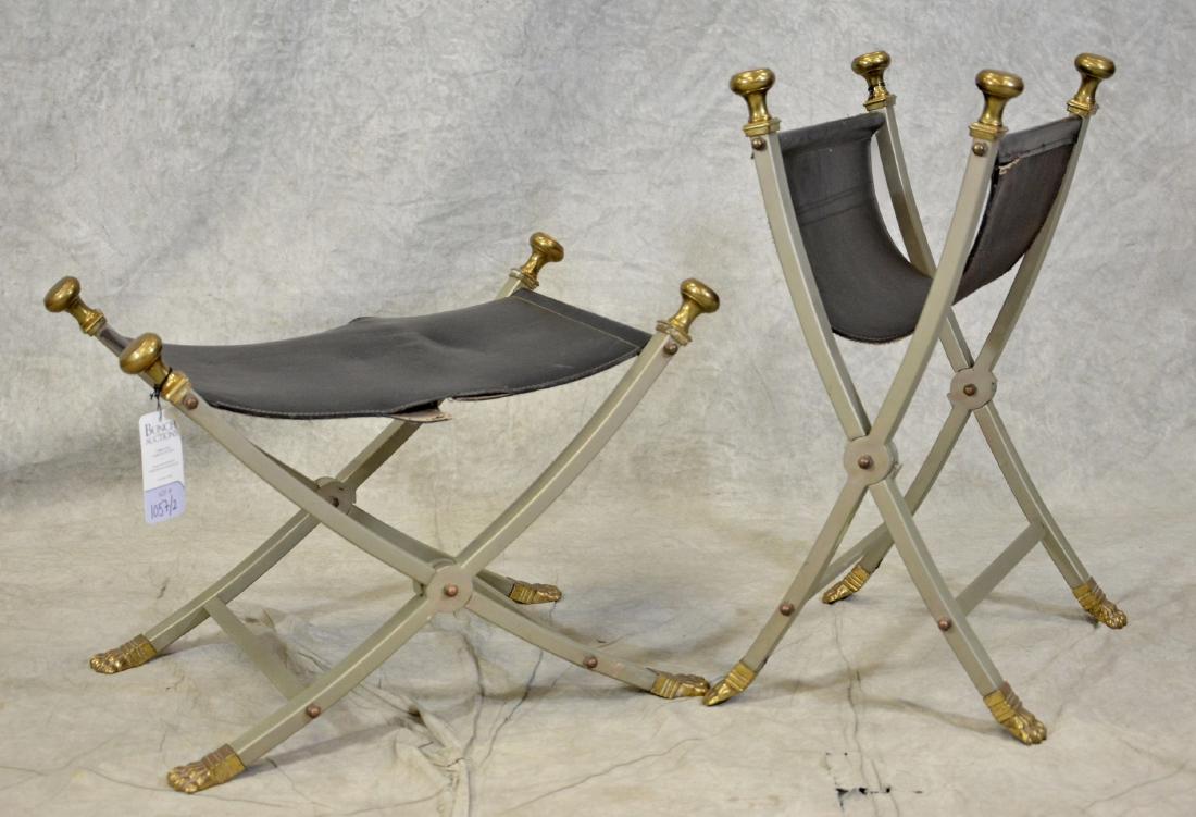 Pair Regency style brass & chrome cerule stools: Pair Regency style brass & chrome cerule stools, black leather seats, brass finials and claw feet, folding chrome x-base, 17-1/4"h x 25-1/2"w x 18"d, one with damage to seat, one with unstitched end