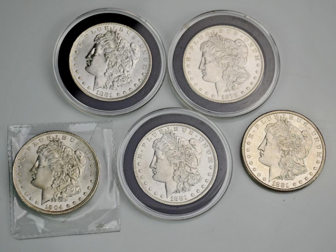 (5) Morgan silver dollars: (5) Morgan silver dollars, (3) O-Mint, (2)1881, 1904, (2) S-Mint, 1878, 1881, 3 in plastic cases, 1 loose, 1 in plastic envelope