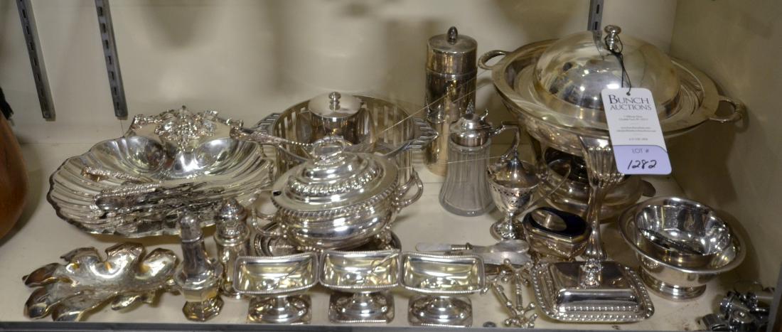 Shelf #10 - Silver Plate: Shelf #10 - Lot of silver plate, including Barker Ellis footed mustard pot, chafing dish, Reed & Barton shell dish, Ward Bennett Design presentation bowl, V Zwanenberg open salts, footed salts, shaker
