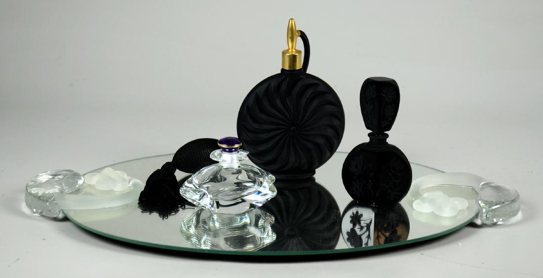 (3) Perfume Bottles & Mirrored Tray: (3) Perfume bottles, including black glass atomizer, intaglio cut black glass, clear art glass with amethyst stopper, and a mirror tray with clear and frosted glass handles, 17-1/2" x 11-1/4", #121, 1