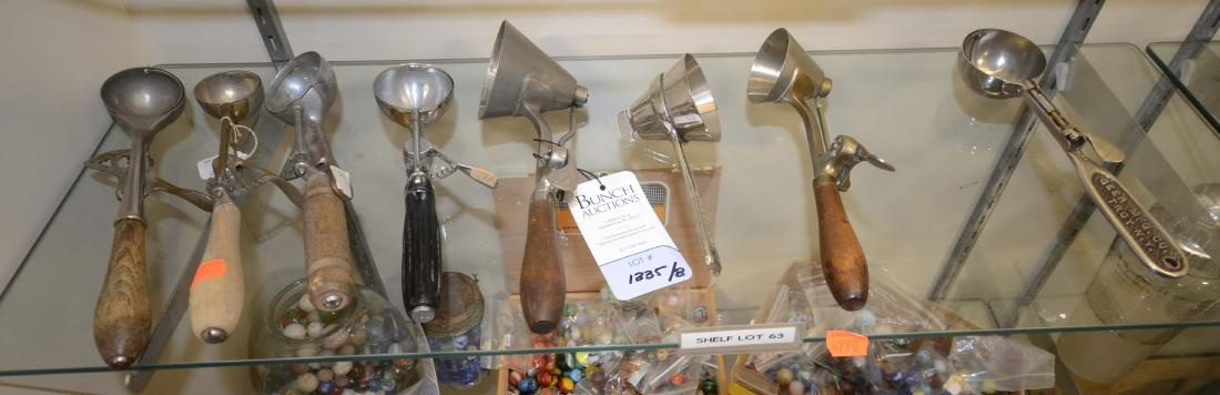 Shelf #63 - (8) Ice Cream Scoops: Shelf #63 - (8) Ice cream scoops to include cone shaped Delmonico, (2) cone shaped Gilchrist's No. 33,(1) Geer Mfg. Co. round scoop, (1) Hamilton Beach round scoop, (1) Gilchrist No. 30 scoop and more