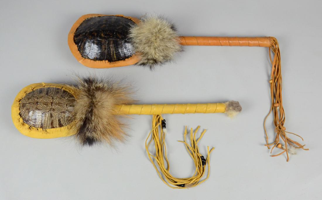 2 Southwest Native American ceremonial turtle shell: 2 Southwest Native American ceremonial turtle shell rattles, sturdy wood handle wrapped in buckskin, decorated with fur and fringe, turtle shell symbolizes longevity,both 20" L