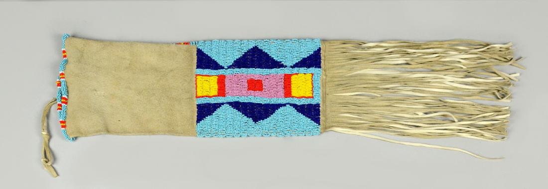 Native American Indian beaded Pipe Bag: Native American Indian Pipe Bag, hide with beaded geometric motif, with turquoise, gren, red, yellow, and white beads, long fringe, 6 - 1/2" W x 15 - 1/2" L without fringe