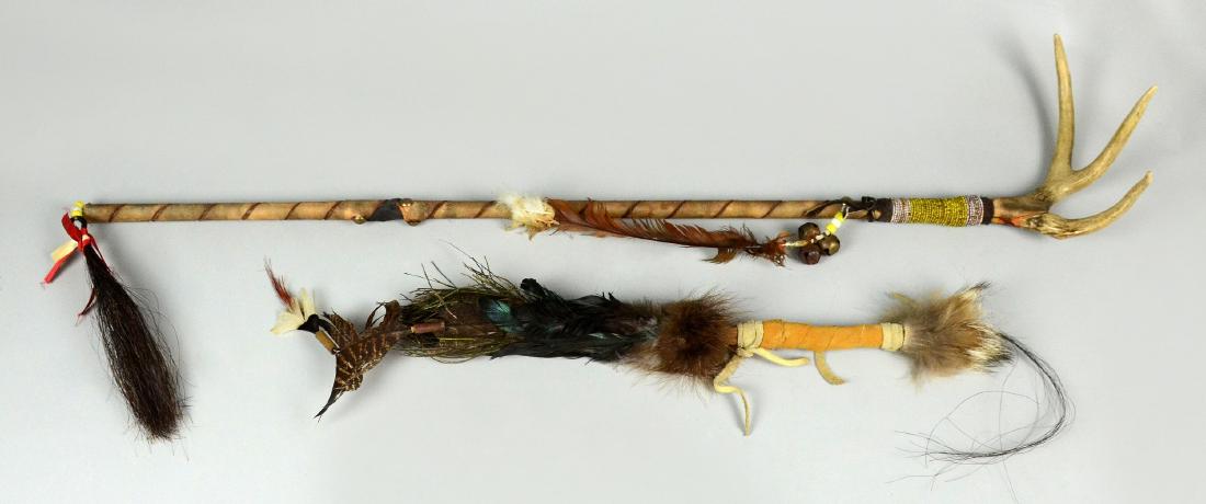 2 Native American Indian Ceremonial Sticks: 2 Native American Indian Ceremonial Sticks. First, wood wrapped in tanned hide, decorated with fur, feathers, and hair. Second, wrapped in hide, antler on one end, adorned with beads, feathers, bells 