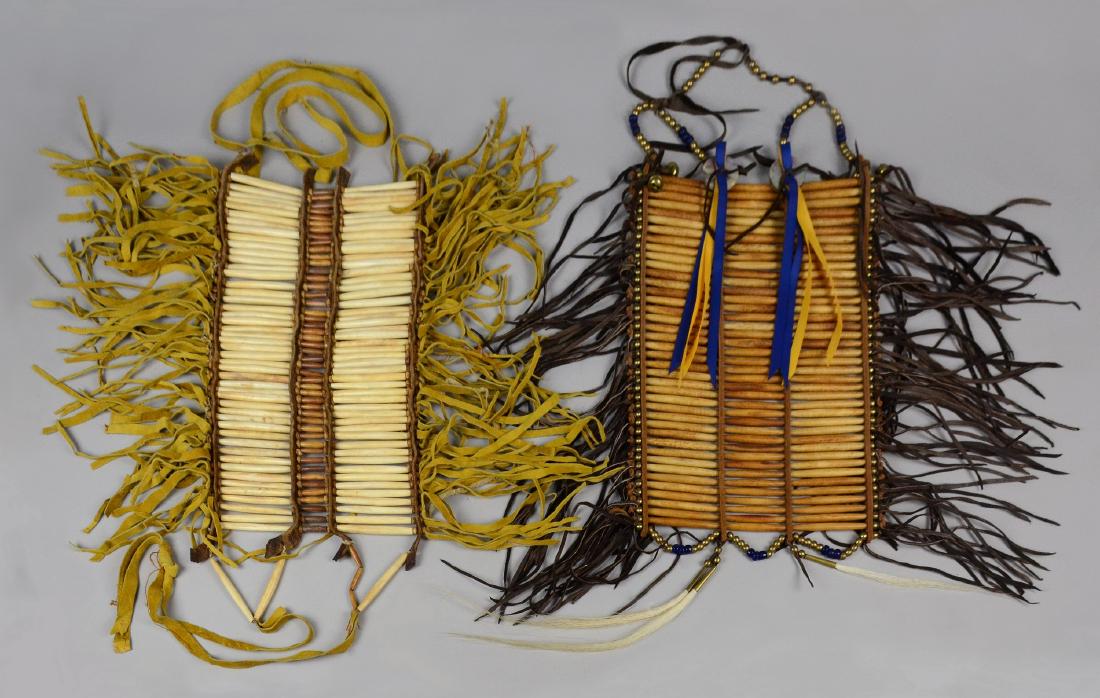 3 Native American Indian breast plates: 3 Native American breast plates. First with bone pipe and fringe, 9" W, 14-1/2" L. Second with bone pipe and blue beaded accents & abalone, 9-1/2" W, 16" L. Third with 3 sections of bone pipe, decorat