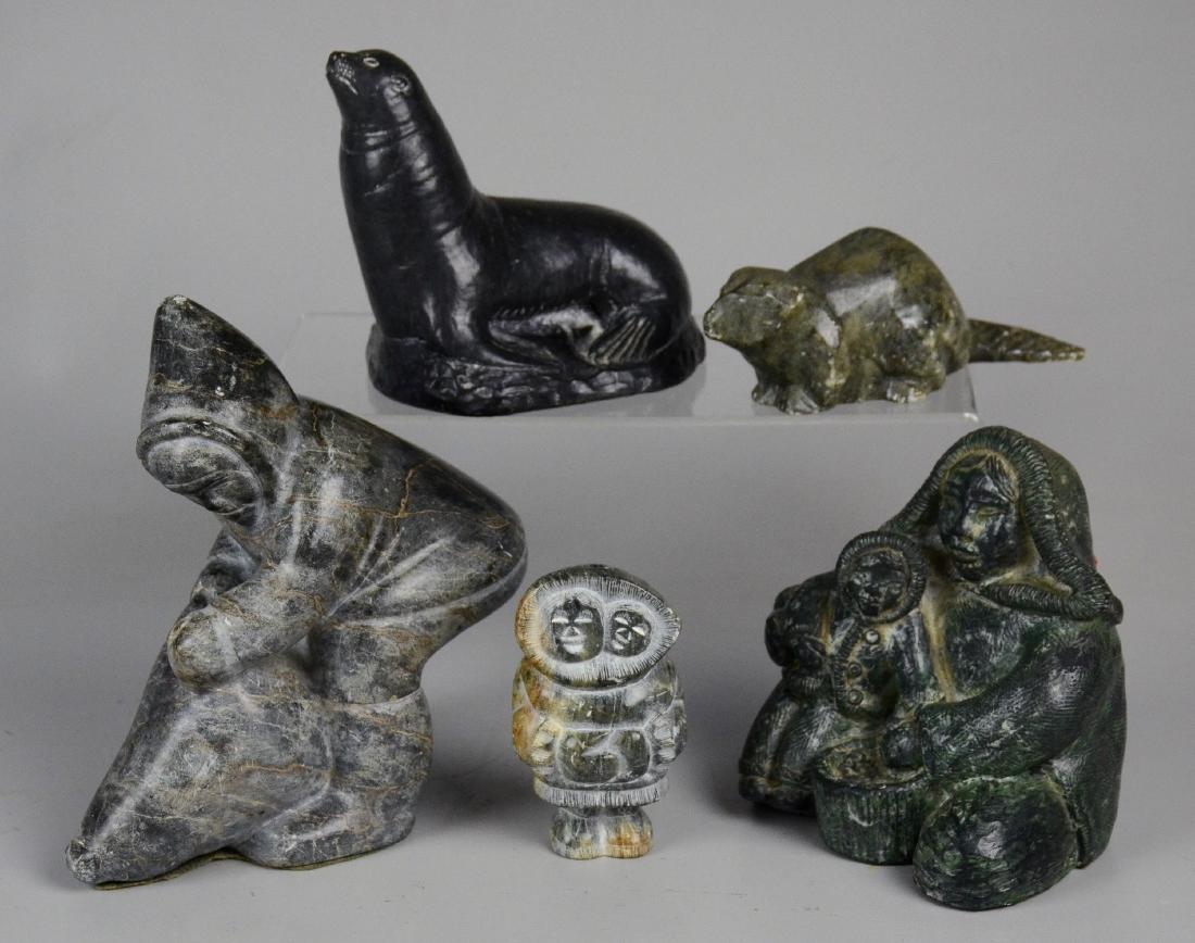 5 Eskimo Inuit Carved Stone Sculptures: 5 Eskimo Inuit Carved Stone Sculptures. First of eskimo grabbing animals horns, wit"Canadian Eskimo Art" sticker on bottom. Second with mother & child eskimo, "The Wolf Sculptures, Handmade in Canada"