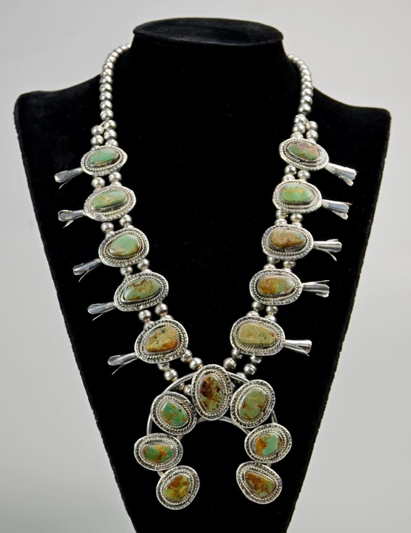 Silver and Turquoise Squash Blossom Necklace: Native American silver & turquoise squash blossom necklace, signed HCL, 7 stone naranja, 10 blossoms, brown variegated stones, 22" long, naranja 3" x 3"