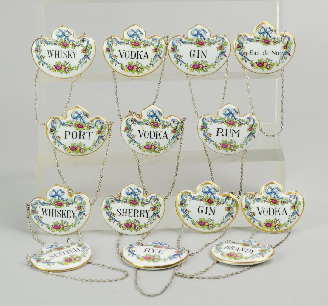 (14) Porcelain Liquor Bottle Labels: (14) Porcelain liquor bottle labels, c/o (6) Crown Staffordshire (Scotch, Whisky, Whiskey, Brandy, Gin, Rye, Sherry, Rum, (2) Vodka), and (3) Coalport (Eau de Nuit, Gin, Vodka, Port), 2" w x 1-33/4" h