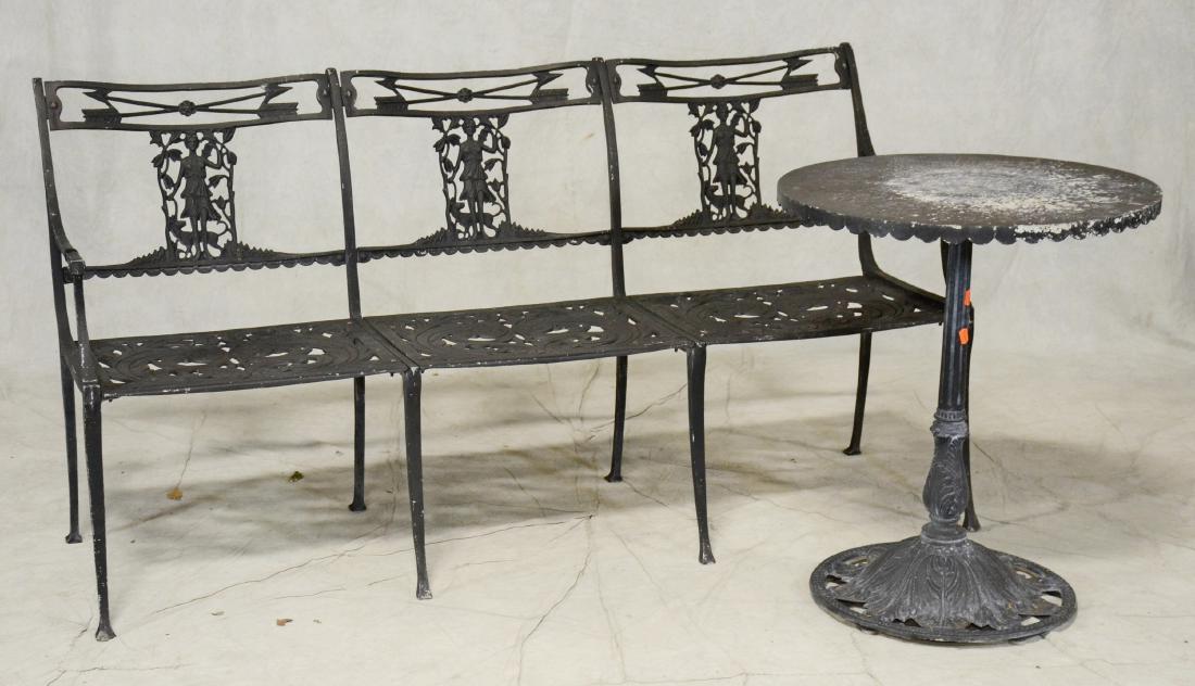 Cast metal patio bench, metal pedestal table: Black cast metal three seat patio bench, metal zodiac side table, bench arrows over a classical woman on a pierced back, acanthus leaf pierced seat, table with scalloped skirt, zodiac signs on top wit