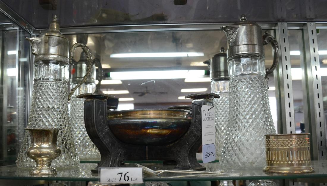 Shelf #76 - Pressed Glass Carafes, Silverplate Epergne: Shelf #76 - Pr pressed glass diamond point carafe pitchers with silverplate handled lids - including one ice insert; Meriden floral engraved silverplate epergne bowl candle holder; Apollo silverplate 
