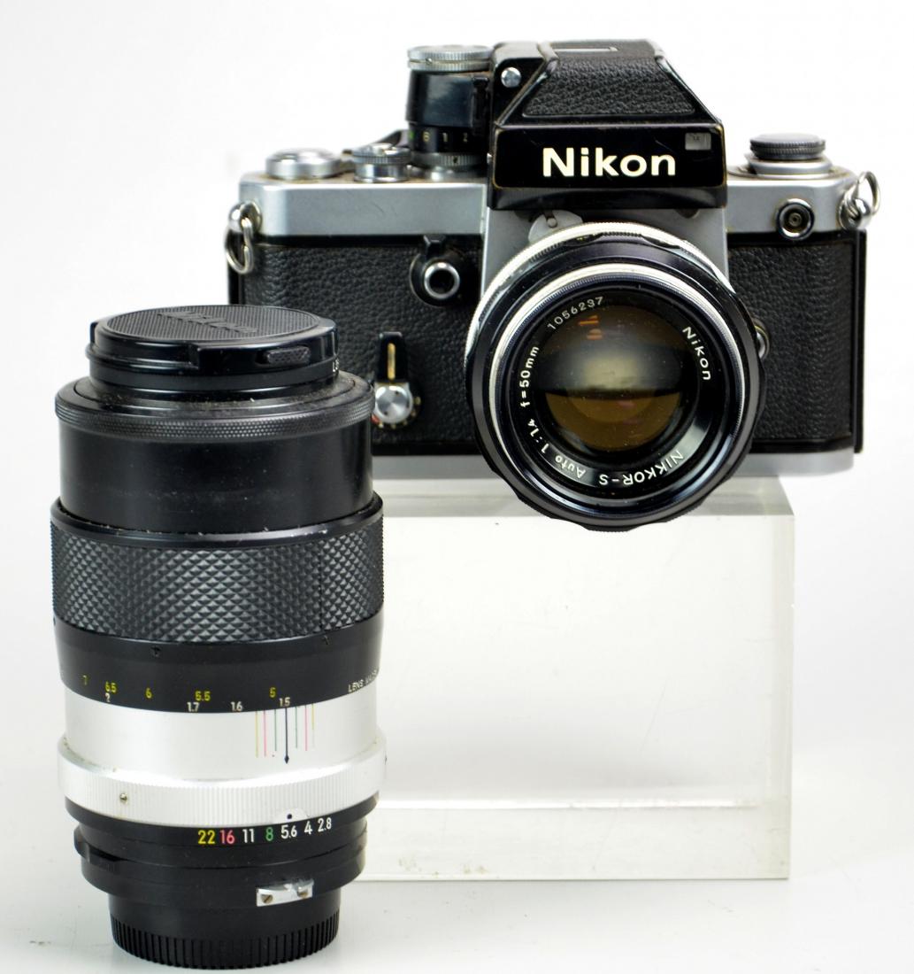 (2) Nikon F2 with 2 lenses: Nikon F2 with DP2 viewfinder and Nikkor-S Auto 1:1.4 f=50mm lens and Nikkor-Q Auto 1:2.8 f=135mm zoom lens. Camera Shutter sticky at 1 second exposure. 4"x6"x4 3/4"