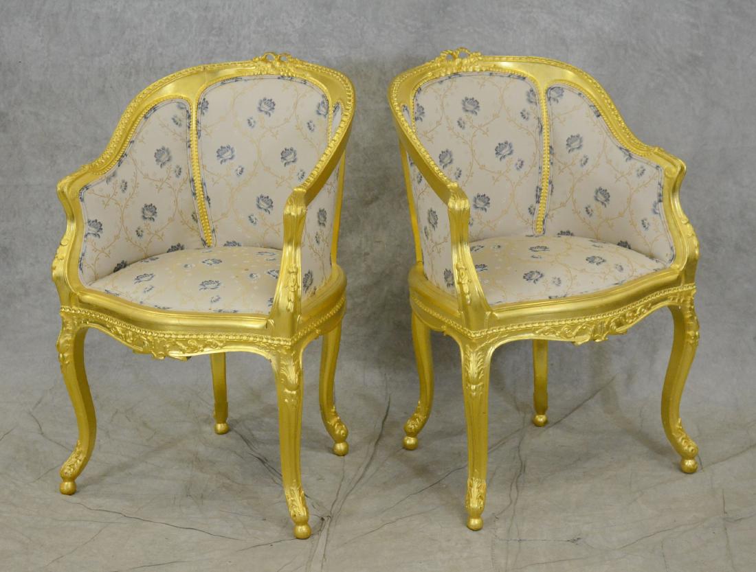 Pair Louis XV style gold painted bergeres: Pair Louis XV style gold painted bergeres, gold painted with bow crest, acanthus leaf and bell flower decoration, blue and cream floral upholstery, cabriole legs with acanthus leaves at knees and feet