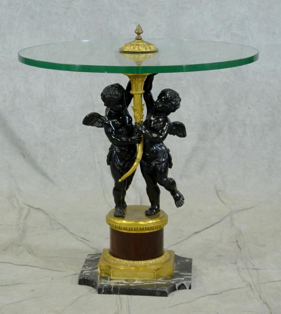 Marble & Bronze Glass Top Table: Marble & Bronze Glass Top Table w/ cherub base, base with black metal cherubs holding a horn on a brass and black metal stand mounted on a marble base, 29"h x 25-3/4"diameter, cherubs are patinated da