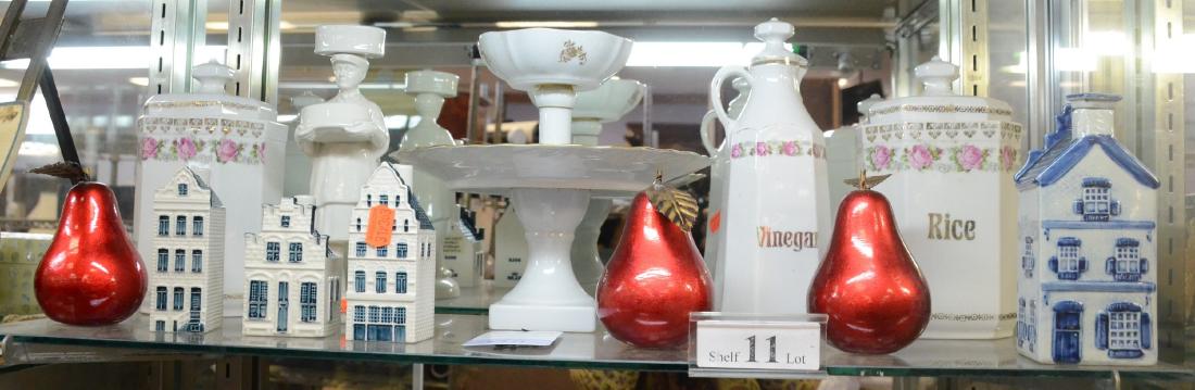 Shelf #11 - Porcelain Lot: Shelf #11 - (3) German Tea, Rice, and Vinegar Containers, Gladstone Pottery of Man Holding a Bowl, Delft Painted House, (3) Bols KLM Houses (# 41, 58, 76), Royal Limoges Compote