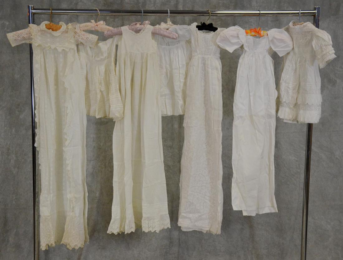 Edwardian Christening Dress Grouping: (7) Piece Edwardian christening group to include (3) full length gowns, (1) full length slip with scalloped lace hem and (3) cotton highly decorated childrens frocks. All pieces include elements of la