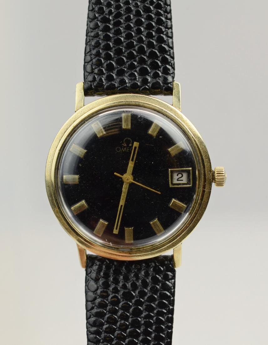 Omega 14K YG wrist watch: Omega 14K YG wrist watch, black date dial, 33 mm case, some scratches to back of case, leather band